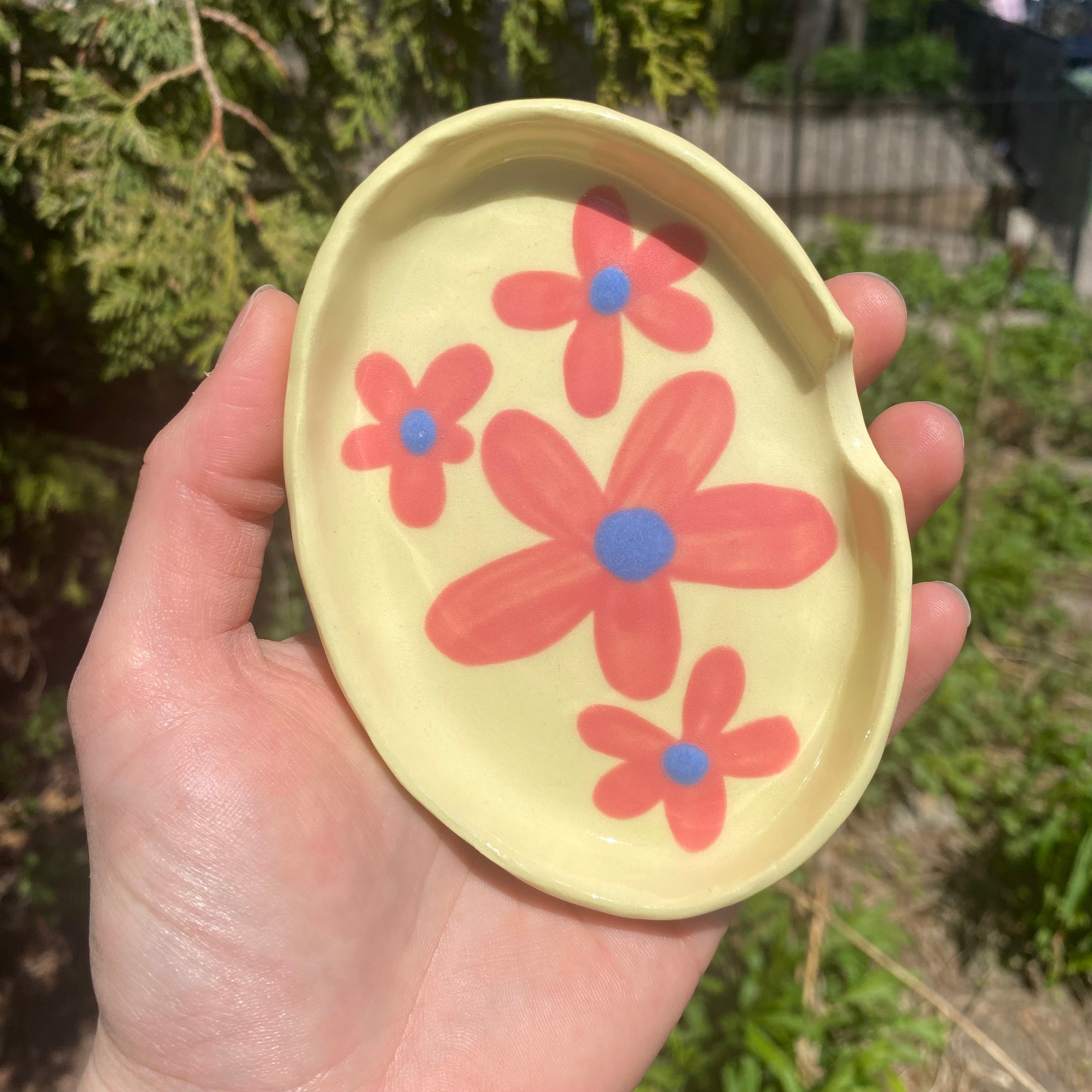 ashtray with pink florals on yellow clay
