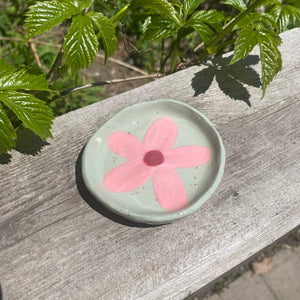 small pink floral dish on sage green clay